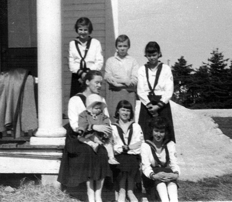 Leading a group of CGIT (Canadian Girls in Training, the United Church's version of Guides) with Heather on her knee, New Mills, NB, 1959